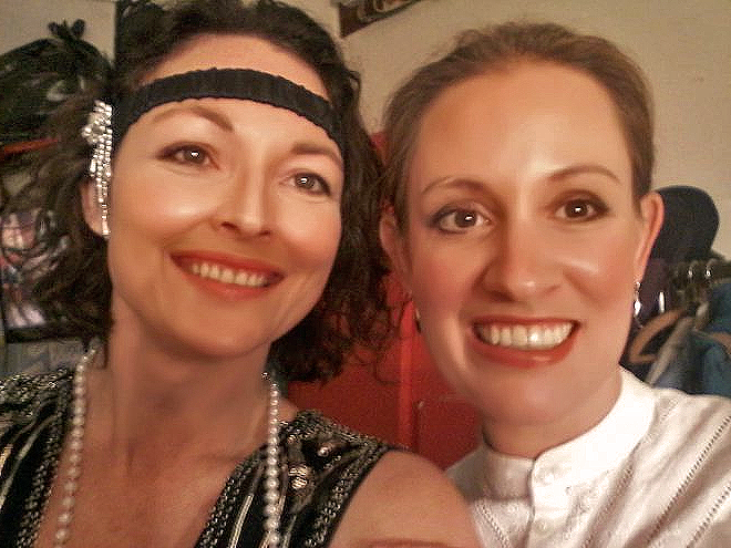 Two members enjoying a backstage moment between scene changes